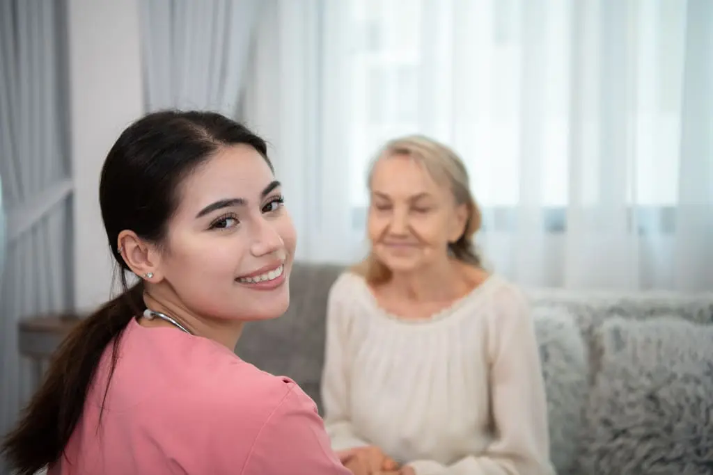 nurse sitting in front of a lady with complex needs